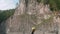 View of river bank with sheer cliffs over river. Panoramic view from floating raft.