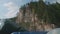 View of river bank with sheer cliffs over river.View from floating raft.