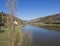 View on river Berounka from pedestrial bridge in village Srbsko in central Bohemian region on on spring sunny day, blue