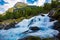 View of the river Geirangerelvi and the waterfall Storfossen in Geiranger, Norway