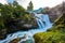 View of the river Geirangerelvi and the waterfall Storfossen in Geiranger, Norway