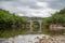 View of the river Herault in the South of France with the bridge of Saint Etienne d'Issensac in the background