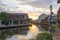 View of river, house and riverwalk with sunrise in Malacca