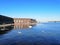 view of the river with ice and sunbathing people in the fortress