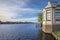 View of a river in the Netherlands, with an old gazebo on the edge, old houses on the other side