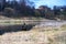 View of the river, on one side of which sits a fisherman, on the other side of a beautiful red house