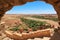 View of the river Onila valley through a hole in a wall of Ancient Kasbah in Ait-Ben-Haddou, Morocco.