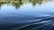 View of the river from the side of the boat. A sports boat rushes towards