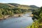 view of river Tweed hills and chain bridge at Melrose in summer