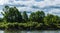 View of the river where a fisherman in a boat catches fish