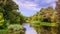 A view of the river with wooded banks, summer natural landscape