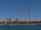 View of the riverbank of Danube River in the north of Vienna, Austria with popular tower Donauturm on sunny day.