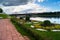 View of the riverside flower bed in the City Park and the old Volga bridge in the background, city of Tver, Russia.