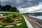 View of the riverside flower bed in the City Park and the old Volga bridge in the background, city of Tver, Russia.