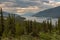 A view from the road of the beautiful Muncho Lake in Canada framed by the pine forests