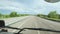 View of the road from the cab of the truck. View of the highway from the cab of the truck