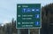 View of road sign with directional arrows point to `Lake Louise` and `Moraine Lake`