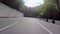 View of road tunnel with yellow light. Scene. Car enters semicircular asphalted long tunnul done in mountain. Road trip