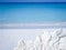 View of a rock created with rocky sand of Cayo Largo (Cuba) on the crystal clear sea background.