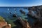 View of the rock formations at the Ponta Joao de Arens, near the Alemao Beach Praia do Alemao on a summer day, with boats on the