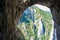 View of the rock walls at Turda gorge Cheile Turzii as seen from under an arch in Hili cave, during a via ferrata route.