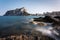 View from the rocks of the coastline with the urban beach of Calpe and the crag in the background, Alicante, Spain