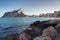 View from the rocks of the coastline with the urban beach of Calpe and the crag in the background, Alicante, Spain