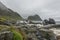 View on a rocky beach on Vaeroy island ( Værøy ) on Lofoten archipelago with a moody stormy sky.