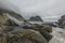 View on a rocky beach on Vaeroy island ( Værøy ) on Lofoten archipelago with a moody stormy sky.