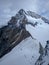 View of the rocky cliff Jungfrau from the top of Jungfraujoch covered with snow, top of Europe in Switzerland. Vertical