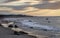 View of rocky coastline against hills with buildings under cloudy sky South Beach Martha's Vineyard