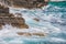 view of rocky seaside waves with white foam