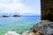 View from the rocky shore to the pleasure boats sailing at anchor in the city harbor Alanya, Turkey