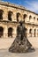 View of the Roman amphitheater in Nimes with the statue of the bullfighter Nimeno