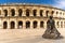 View of the Roman amphitheater in Nimes with the statue of the bullfighter Nimeno