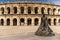 View of the Roman amphitheater in Nimes with the statue of the bullfighter Nimeno