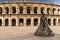 View of the Roman amphitheater in Nimes with the statue of the bullfighter Nimeno