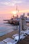 View of romantic sunrise sky, sea and platform with empty sun loungers and umbrellas.