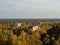 View from roof of ghost town Pripyat, post apocalyptic city and new sarcophagus of Chernobyl nuclear plant autumn season in