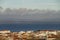 View of the roofs of a country in Sardinia with a varied sky in layers that generates a pleasant visual effect