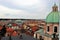 View of the roofs of old Prague from the side of a Catholic cathedral.