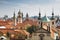 View of the roofs of Prague, with red tiled roofs and statues,