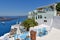 View of rooftop bar in the Greek island of Santorini overlooking the blue Aegean sea.