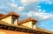 View of rooftop and sky with clouds at sunset. Roof tiles