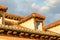 View of rooftop and sky with clouds at sunset. Roof tiles