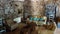 View into room of french cottage built of natural materials in style prevencale with stone wall and antique furniture