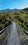 View on rope Tibetan steel bridge in mountain