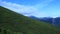 A view from a ropeway to a moving mountain landscape.