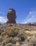view on Roque Cinchado gods finger, famous rock formation in Roques de Garcia el teide national park with dry vegetation and