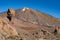 View of Roques de GarcÃ­a unique rock formation with famous Pico del Teide mountain volcano summit in the background on a sunrise